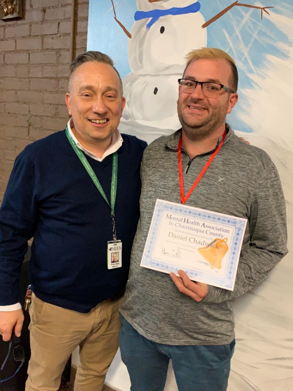 At the October Recovery Luncheon, Mental Health Association in Chautauqua County Executive Director Steven Cobb (left) presented participant David Chadwick with a certificate of recognition. Chadwick found employment through the MHA OPEN program that is focused on workforce development.