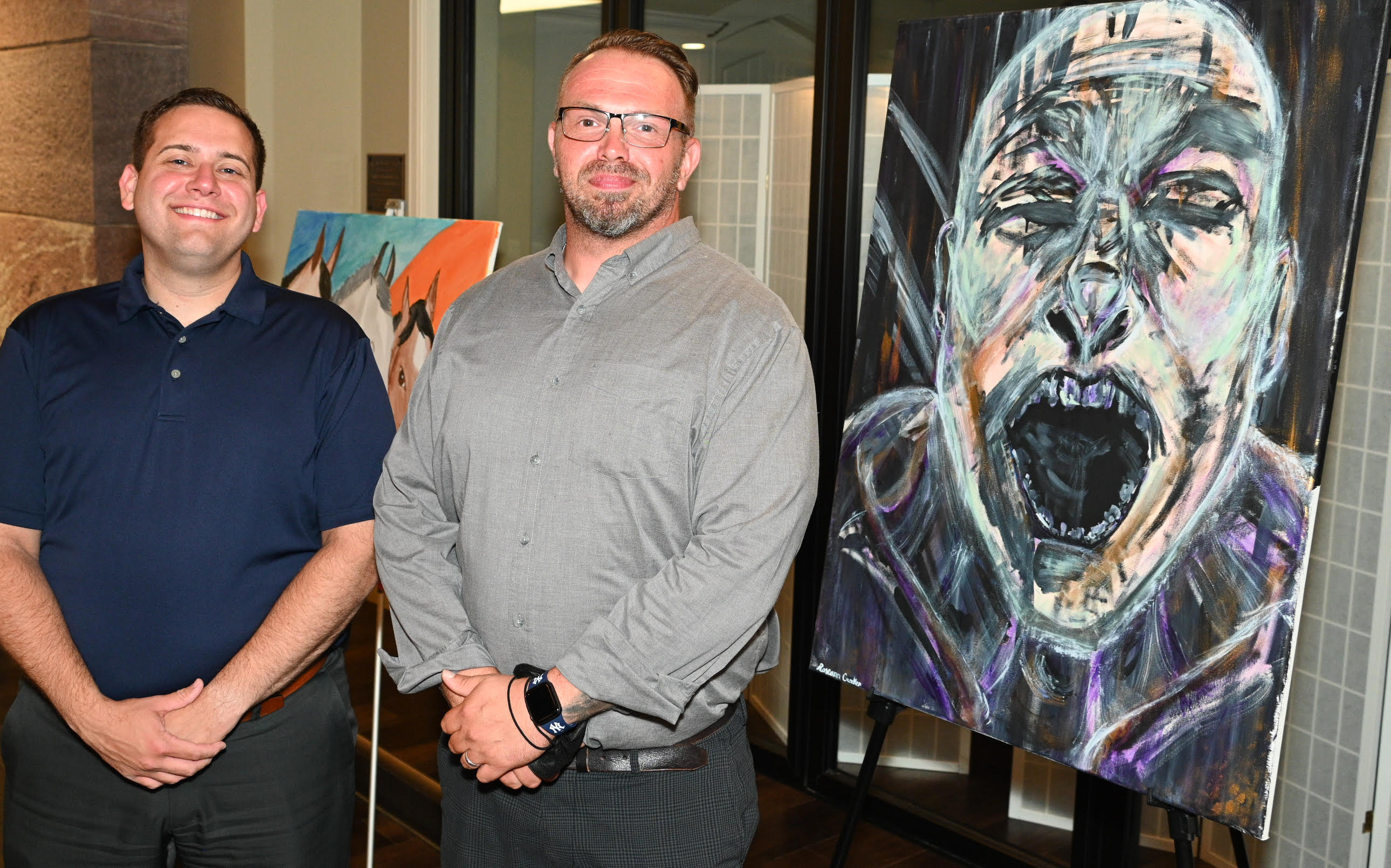St. Luke’s Episcopal Church was the venue for the recent Art of Recovery exhibit presented by St. Luke’s and the Mental Health Association in Chautauqua County (MHA). One of the visitors, Jamestown Mayor Eddie Sundquist (left), is pictured with MHA staffer Sean Jones beside the painting “Francis Bacon Study” by Roseann Crocke.