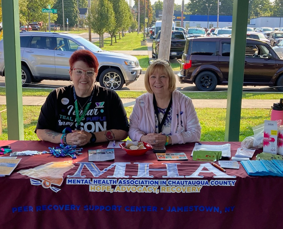 Volunteer Tina Morgan (left) and Activities Director Dianne Valvo represented the Mental Health Association in Chautauqua County at the Suicide Prevention Alliance of Chautauqua County’s Out of the Darkness Walk at Jamestown’s Jackson Taylor Park.