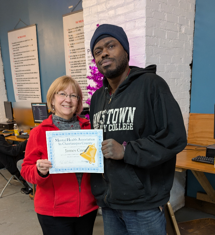 James Coon was recognized for his accomplishments at the January recovery luncheon of the Mental Health Association in Chautauqua County. He is pictured receiving a certificate from Activities/Public Relations Manager Dianne Valvo.