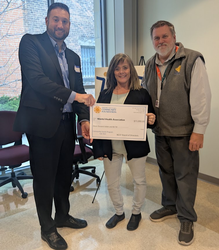 Mental Health Association in Chautauqua County Executive Director Michael Nordin, right, and Grants Manager Michelle Colaiacovo are presented a generous grant from the Northern Chautauqua Community Foundation by Foundation board member Adam Dimitri. 